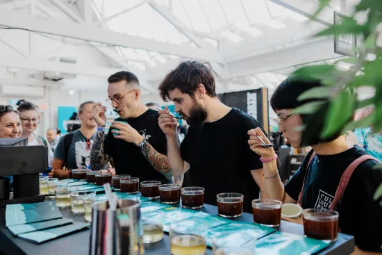 Three people slurp coffee at a cupping at last year's BCF.