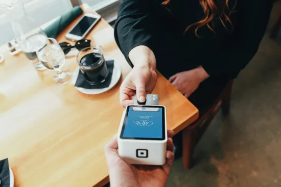 A customer pays on a Square brand card reader.