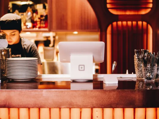 A café's counter with a cash register. 