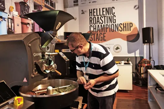 A Hellenic Roasting Championship competitor looks over beans roasting.