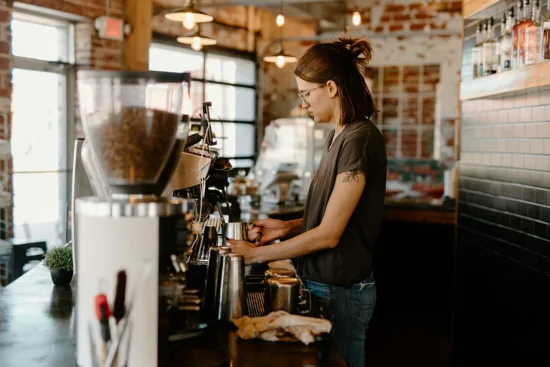 A barista works behind the espresso bar.