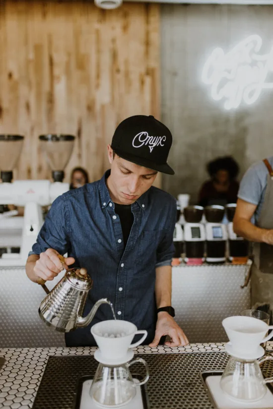 Dylan pours a pourover.