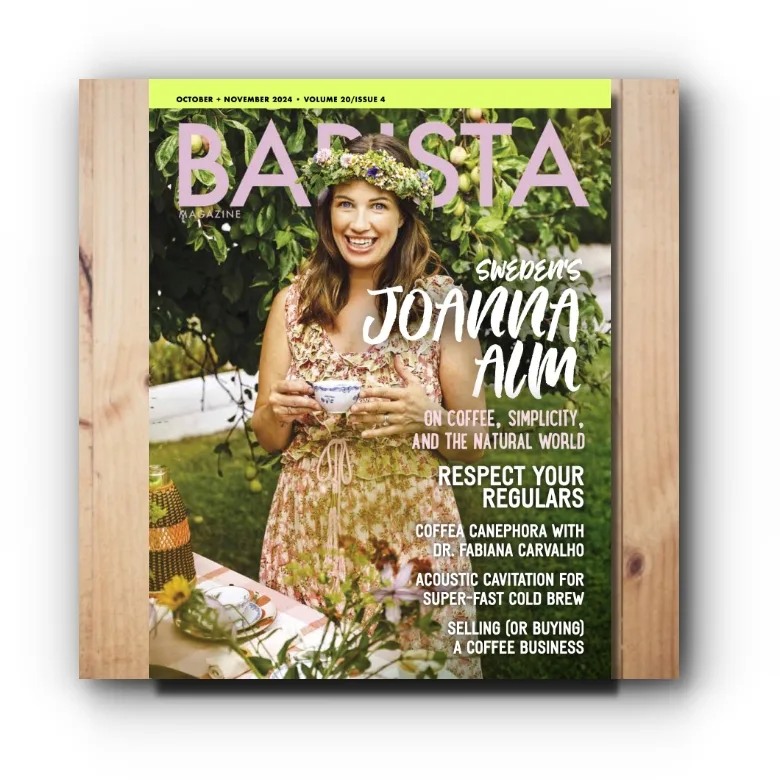 Barista Magazine October + November 2024 issue on a wooden background.