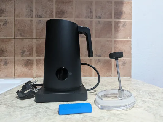 The NanoFoamer PRO GEN-2 on its stand unplugged, with the lid and blue flow control attachment.