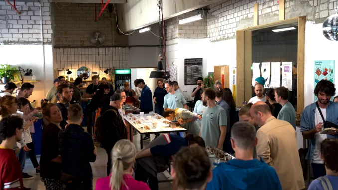 Large group gathered around a tasting table.