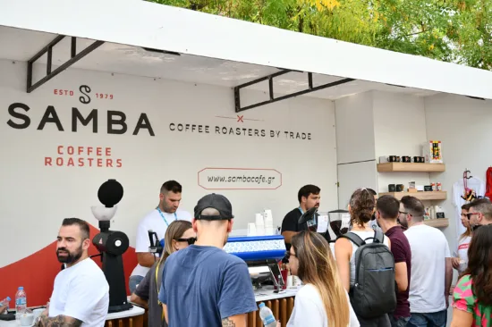 Samba hosts a booth at Athens Coffee Fest with an espresso machine.