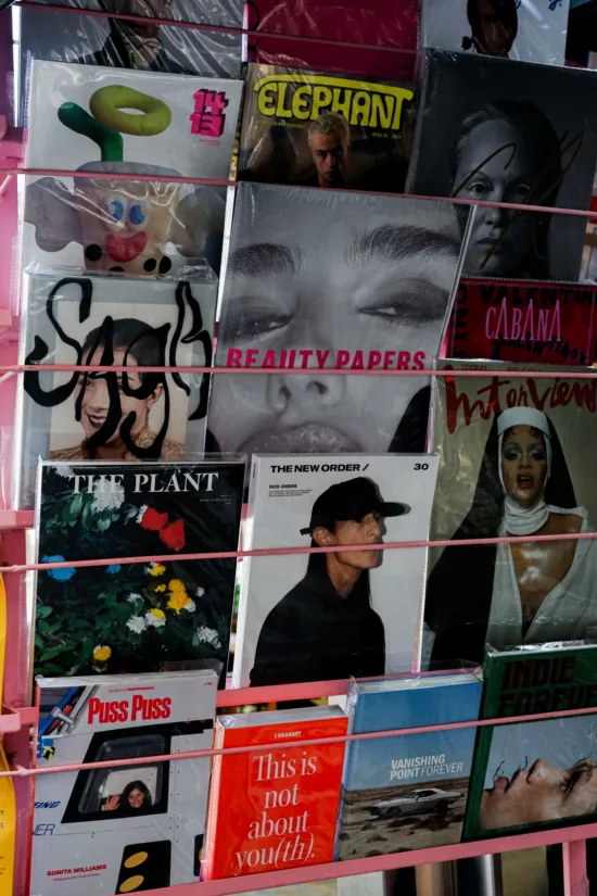 A rack of magazines with artists and musicians.