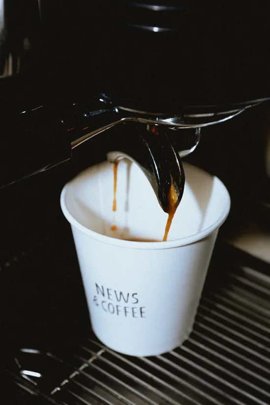 Espresso pulling into a News & Coffee paper cup.