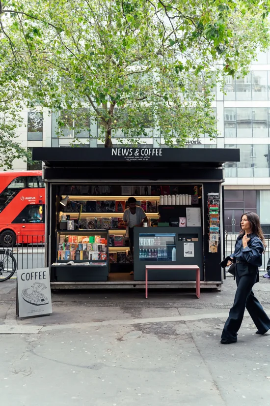 A News & Coffee stand on a sidewalk.