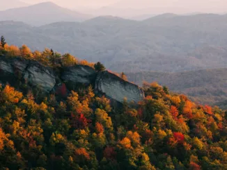 A North Carolina mountain ridge dotted with colorful autumn trees.