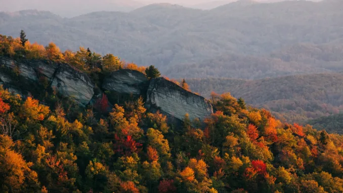 A North Carolina mountain ridge dotted with colorful autumn trees.