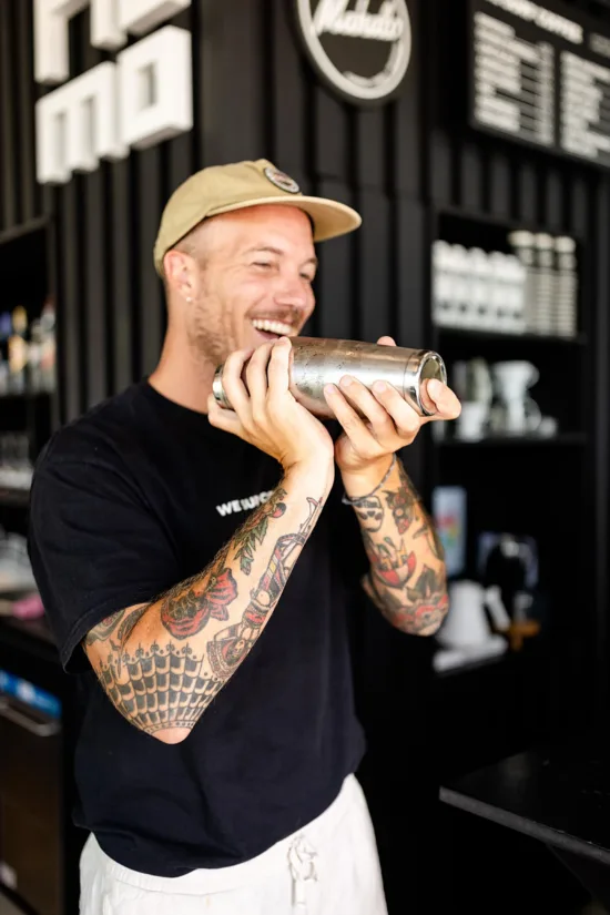 Jérôme makes a drink with a cocktail shaker.