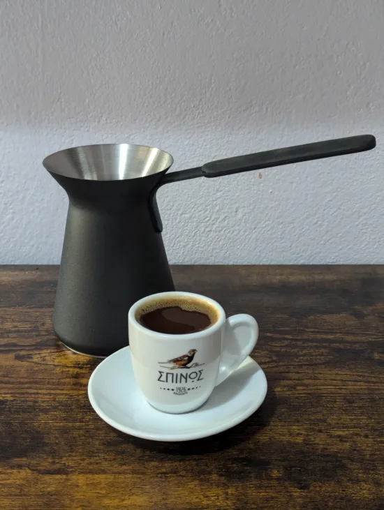 Ibrik with a small coffee cup and saucer for Turkish style coffee.