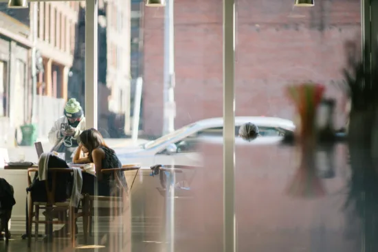 People sitting inside a bright café.