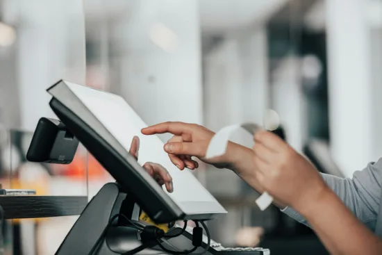 Cashier ringing in an order on a cash register.